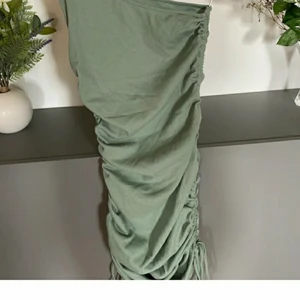 Fin enaxlad klänning med snörning - Tajt snygg klänning med frågan i snörning på sidorna. En axlar du kan välja om du vill ha om du vill ha den över höger eller vänster Axel. 