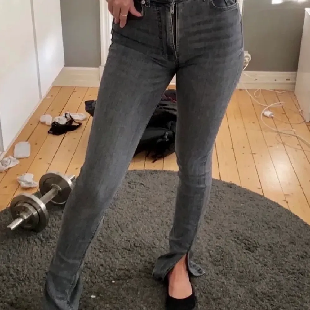 Populära gråa jeans från zara med slits. De är lånade bilder!!!! Kom privat för egna. Väldigt fint skick, knappt använda men ganska strestchiga så passar storleken 38-40. Jeans & Byxor.