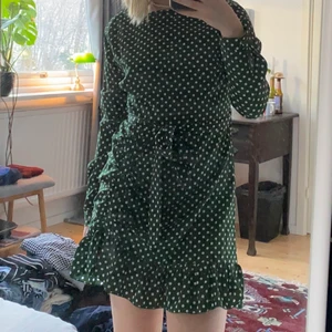 Grönprickig klänning - Prickig klänning i superfin grön färg från Missguided 🌺 Det finns ett skärp-band till som man kan ta bort om man vill. På ena sidan av själva kjolen är det knappar (bild 3). Använd en gång på julafton förrförra året :)