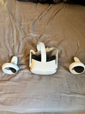 Meta Quest 2 (128gb) (hämtas upp i Gällstad) - Säljer ett Oculus Quest 2 VR-headset i vit plast med matchande handkontroller. Headsetet har justerbart band och bekväm vaddering runt ögonen. Perfekt för gaming och VR-upplevelser, trådlös och enkel att använda.                                          (Kommer utan laddare till vr)