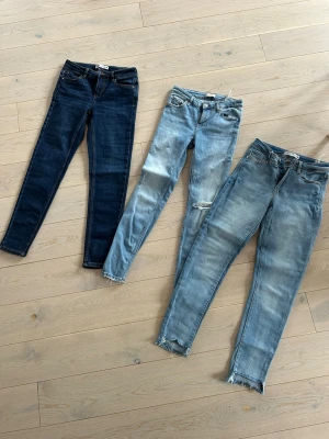 Tre par skinny jeans i olika tvättar - Säljer tre par skinny jeans i olika blå tvättar. Ett par är mörkblå, de andra två är ljusblå. Alla har klassisk femficksdesign och normal midja. Perfekta för dig som gillar trendiga och bekväma jeans med lite edge. Pris 75kr/st. Finns i Växjö.