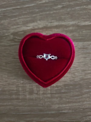 Silverfärgad ring med hjärtformad sten - ring i storlek 17,3mm, silverfärgad. 