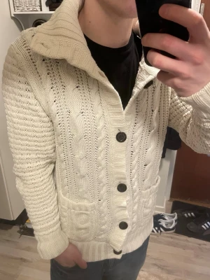 Vit stickad cardigan - Otroligt snygg vit stickad cardigan. Passar perfekt till kallare väder. Modellen är 180cm, 75kg. Priset kan såklart diksuteras