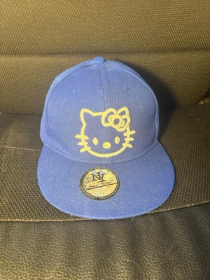 Hello kitty keps  - Säljer denna hello Kitty kepsen då den inte kommer till användning, rekommenderar att kolla innan så att den passar då den är ganska liten och kan ej justeras, omkrets 56,8cm💕