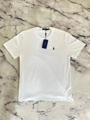 Ralph Lauren T-shirt  - En mycket fin aldrig använd T-shirt ifrån Ralph Lauren. Plagget köptes som en present men kom aldrig till användning pga för stor storlek.  Priset kan diskuteras!