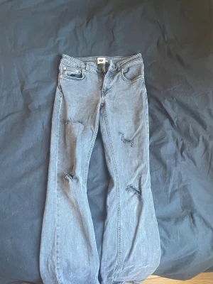 Grå slitna jeans från 157 - Storlek- S lång Ett par grå jeans från 157 med flare ben och slitningar på både lår och knän. Klassisk femficksmodell med knapp och dragkedja framtill. (klicka ej köp nu) Swish går 👍 