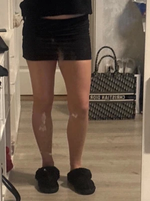 Svart kortkjol  - Enkel och stilren svart kortkjol i mjukt bomullsmaterial. Kjolen har en tight passform och klassisk rak design utan synliga detaljer. Perfekt att matcha med olika toppar för en clean look.