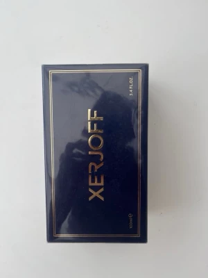 Xerjoff parfym 100ml mörkblå - Lyxig parfym från Xerjoff i en elegant mörkblå förpackning med guldfärgade detaljer. Förpackningen rymmer 100 ml och har en stilren, rektangulär form med exklusiv känsla. Perfekt för dig som gillar exklusiva dofter och snygg design.