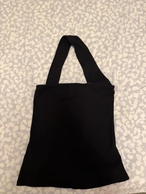 Svart ribbad fest topp - Snygg svart ribbad linnetopp från Nelly. Toppen har breda axelband och ärmlös design. Aldrig använd!