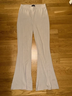 Beiga utsvängda mjukisbyxor Even&Odd - Säljer ett par beiga mjukisbyxor från Even&Odd med utsvängda ben och bred resår i midjan. Byxorna är gjorda i ett mjukt och stretchigt material som känns skönt mot huden. Perfekta för en avslappnad och trendig look.