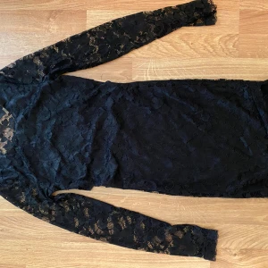 Svart spetsklänning - Spetsklänning med halvt öppen rygg