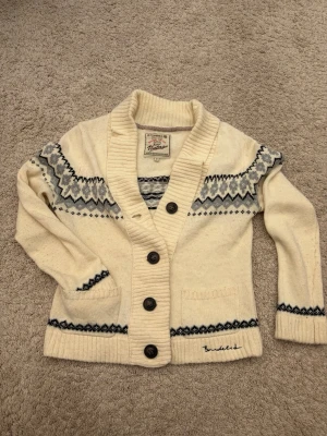 Vit mönstrad cardigan kofta från Bondelid - Säljer en snygg vit mönstrad cardigan kofta från Bondelid. Storlek medium men sitter mer som small/medium. Fint skick och inga skador!