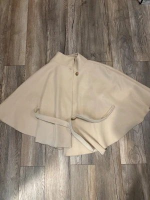 Beige poncho - Stilren beige från missäy.