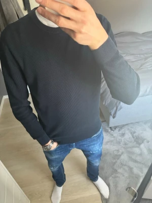 Marinblå ribbad tröja från Zara - En stilren mörkblå ribbad tröja med rund halsringning och långa ärmar. Tröjan har en enkel och clean design som passar till det mesta. 