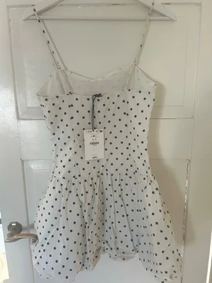 Prickig miniklänning  - Kort klänning med tight passform upptill och ballongkjol smala reglerbara axelband. Aldrig använd och har prislappen kvar, så är i toppskick!💝💝