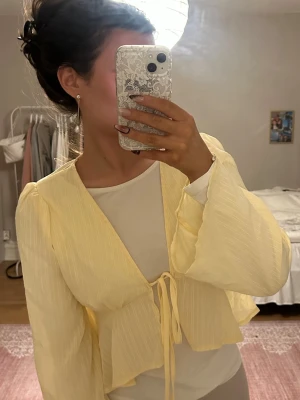 Gul blus med knytband och vida ärmar - Söt ljusgul blus med långa, vida ärmar och knytband framtill💛