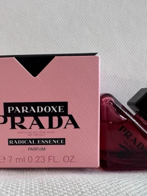 Prada Paradoxe Radical Essence Parfym - Upptäck Prada Paradoxe Radical Essence, en exklusiv parfym i en unik trekantig flaska av mörkrosa glas med svart kork. Kommer i en snygg rosa kartong med svarta detaljer. Doften är intensiv och modern, perfekt för dig som vill sticka ut.