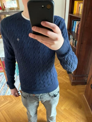 Blå stickad Morris tröja - Marinblå kabelstickad tröja från Morris 🧵 Storlek M, Passar S. Använd få gånger, nästan nyskick – inga fläckar eller slitage. Snygg och klassisk, passar både vardag och finare tillfällen.                                                                 Skicka om ni har fler frågor 