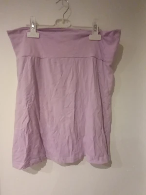 Ljuslila tubtopp från Crossbow - Säljer en enkel och stilren ljuslila tubtopp från Crossbow i mjukt bomullsmaterial. Toppen är axelbandslös och har en rak, avslappnad passform som passar perfekt till sommaren.