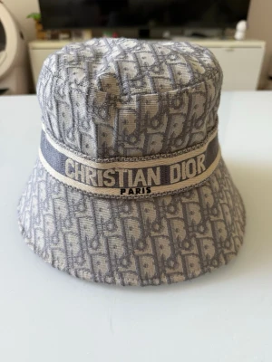 Christian Dior bucket hat - Säljer en snygg bucket hat från Christian Dior kommer i nycskick med lappar,     Kan mötas men även frakta vid snappafäär kan gå ner i pris