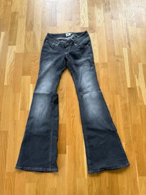 Lågmidjade jeans  - Snygga mörkgrå/ljusgrå bootcut jeans från lager157. Midjemåttet: 36cm, Innerbenslängd: 86cm