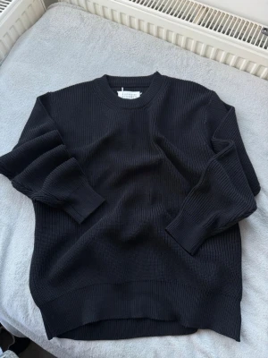 Maison Margiela Black Knit Sweater – Minimal Essential - Maison Margiela black knitted sweater.  Timeless minimal design with premium construction. Soft structured knit with relaxed luxury feel.  Great condition. Perfect layering piece.  Serious offers welcome.