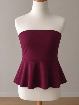 MISSÄY peplum tubtopp - Säljer en vinröd tubtopp med peplumskärning. Toppen är axelbandslös och har en snygg, utsvängd nederdel som ger en feminin siluett. Perfekt att styla med jeans eller kjol för en trendig look.