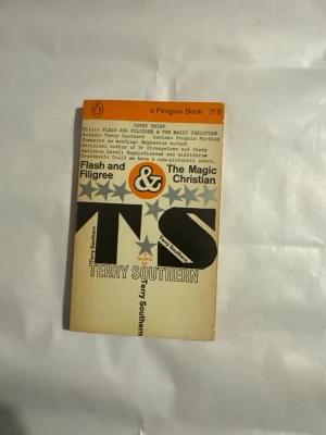 Flash and Filigree & The Magic Christian - Säljer en engelsk pocketbok med titlarna Flash and Filigree & The Magic Christian av Terry Southern. Boken har ett retro omslag i orange, grått och svart med stjärnmönster och stora bokstäver. Perfekt för dig som gillar klassisk skönlitteratur och samlarutgåvor.