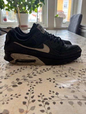 Nike Air Max svarta sneakers - 45 - Lite mer använda men fortfarande i bra skick. Unik och sällsynt färgkombination som inte syns ofta. Klassisk Air Max 90-silhuett med ikonisk komfort och stil. Perfekta för sneakerheads eller som ett standout-par i garderoben. Storlek 45