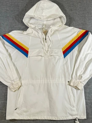 Vintage Pullover Quater Zip Windbreaker 90s Colorblock - Brand: A by Torsta Size: 42 (fits M/L) Material: 100% Cotton Color: White / Red / Yellow / Blue Fit: Relaxed anorak Made: Finland Measurements: Waist 56 cm, P2P 59 cm, Length 73 cm, Sleeve (to neck) 82.5 cm  Compare measurements for best fit  Attention: These have been worn and used, skip if you want new.  Clean 90s Scandinavian anorak with bold stripe detail and embroidered sleeve logo. Lightweight and easy to style.