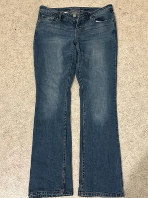 Blå bootcut jeans från Express - Snygga blå bootcut jeans från Aeropastle med klassisk femficksdesign och subtila slitningar framtill. Jeansen har normal midja och är tillverkade i mjukt denimtyg som ger en bekväm passform. Perfekta för en avslappnad och trendig look. Pris kan diskuteras!