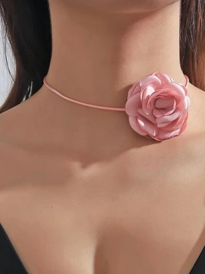 Choker halsband Necklace med rosa tygblomma - Supersöt choker med en stor rosa tygblomma i mitten. Halsbandet har ett tunt rosa band och justerbart spänne i metall. Perfekt för dig som vill ha en romantisk och trendig detalj till din outfit. Blomman är gjord av tyg och ger en mjuk, feminin look.