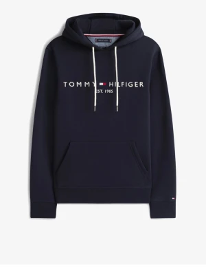 Marinblå hoodie Tommy Hilfiger - Snygg marinblå hoodie från Tommy Hilfiger med vit logga och texten 'EST. 1985' på bröstet. Hoodien har vit dragsko i huvan och en stor magficka framtill. Tillverkad i mjukt bomullsmaterial och har ribbade muddar vid ärmslut och nederkant. Ny pris ca 900kr, säljer för halva priset!