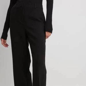 Kostymbyxor svarta  - Skräddarsydda kostymbyxor med mellanhög midja. Helt oanvända i originalförpackningen. 