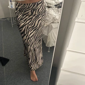 Lång zebramönstrad kjol - Säljer denna oanvända zebramönstade maxikjol i storlek 40! Superfin i silke! 🩷