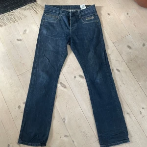 Mörkblå jeans - Mörkblå jeans i en fin modell, detaljer på fickorna, hål längst ner på byxornas ben, pris går att diskutera