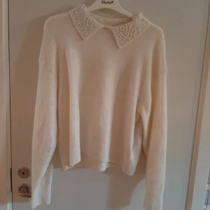 Stickad tröja med krage - I ett mycket bra skick, endast använd ett fåtal gånger. Vit/crèmefärgad.