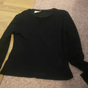 En svart tunn tröja som är lite genomskinlig, säljer pågrund av att den är för liten.