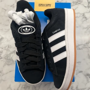 Adidas Campus 00s ”Black Gum” (Junior) - Helt nya och oanvända Adidas Campus 00s ”Black Gum” i juniormodellen. Storlek: 38 2/3. Pris: 1299+frakt. Skicka ett meddelande vid intresse. Köp tryggt och snabbt hos oss. Många nöjda kunder😊