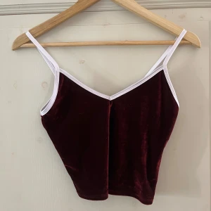 Röd sammet linne - Söt topp i sammet med vita detaljer. Perfekt för en festlig look eller en casual outfit. Aldrig använd innan lappen hata bara ramlat av