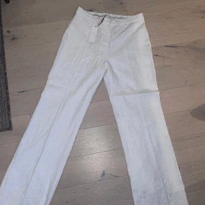 Linnebyxor - Kritvita hellånga linnebyxor, storlek 38. Helt nya med prislapp. Säljer pga lite stora och för långa för mig 