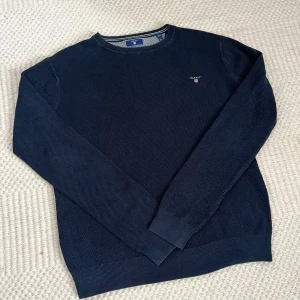 Marinblå stickad sweatshirt från GANT - Tunn stickad sweatshirt från GANT! Använd mindre än 10 gånger, mycket bra skick och inget slitage. Storlek S, normal i storleken. Nypris 1300.