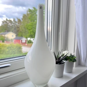 Vit vit - Säljer en vit vas med långsmal hals och bredare botten. Inköpt på ikea för många år sedan och är knappt använd. Önskar du veta exakta mått? Tveka inte att höra av dig!