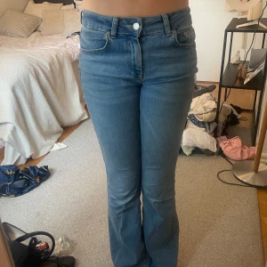 Blå bootcut jeans från Lager 157 - Säljer ett par klassiska blå  jeans med bootcut passform och lågmidja. Jeansen är i mjukt denimtyg och har fem fickor samt dragkedja och knapp framtill. Perfekta för dig som gillar en tidlös och snygg look.