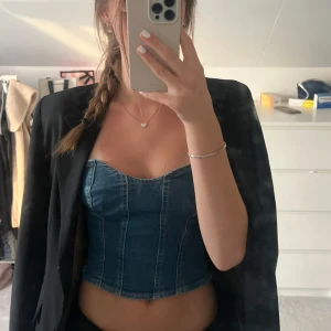 Jeanskorsett från Stradivarius  - Säljer en snygg jeanskorsett från Stradivarius i storlek XS. Toppen är i blå denim med markerade sömmar och dragkedja där bak. Den är köpt från Sellpy men jag har aldrig använt den🥰