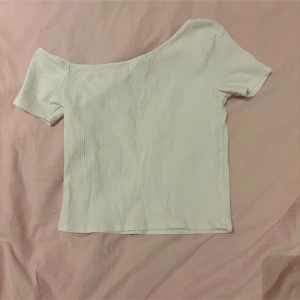 Vit ribbad offshoulder topp Zara - Vit ribbad topp från Zara med offshoulder-design och korta ärmar. Strl 164 sitter som xs. Fint skick. Pris 40 kr. 