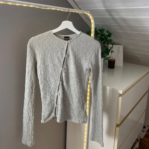 Ljusgrön topp från Gina Tricot XS - Supersöt ljusgrön topp från Gina Tricot i storlek XS. Den har ett skrynkligt tyg och knappar snett framtill. Har tagit bort prislappen, men aldrig använd