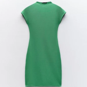 Grön klänning från Zara - Snygg grön klänning från Zara med korta ärmar och en enkel, stilren design. Perfekt för en chic och modern look. Klänningen har en normal passform och är tillverkad i ett mjukt material. Har i grå och vit färg också som jag säljer! 