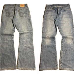 Blå bootcut jeans från Levi's - Säljer ett par klassiska blå bootcut jeans från Levi's. De har en snygg tvättad look och femficksdesign. Perfekta för en avslappnad stil. Mått (100cm Length) (40cm Waist) (25cm Leg opening)