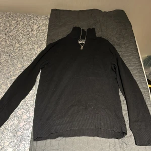 Svart half zip  - Svart half zip från Jack&Jones. Den är använd några gånger och är i bra skick . Säljer pågrund av att den är för liten. Ny pris ligger runt 400kr och mitt pris är 150kr. Skriv gärna om du är sugen på att köpa.
